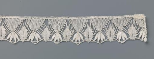 Strip of bobbin lace with leaf border