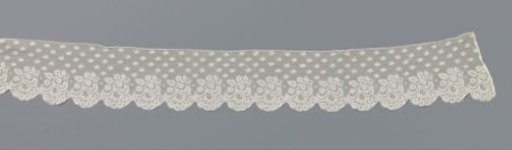 Strip of bobbin lace with hanging leaf branch