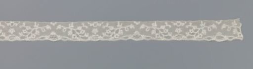 Strip of bobbin lace with turned branches