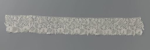 Strip of needle lace with cut-out leaf