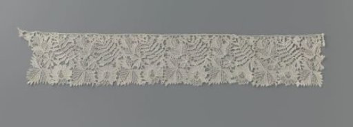 Strip of needle lace with cut-out leaf