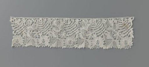 Strip of needle lace with cut-out leaf