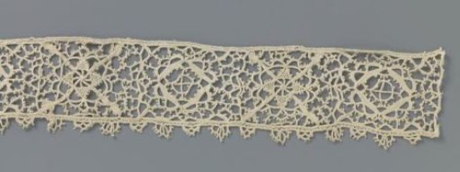 Strip of crocheted lace with reticella motifs
