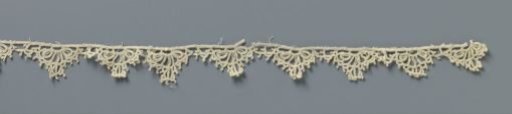 Strip of crocheted lace with fan-shaped reticella shells