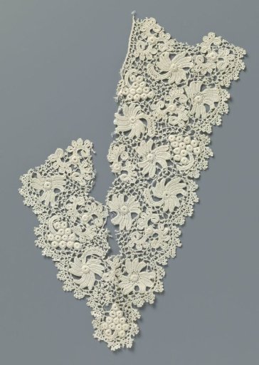 Fragment of crochet lace with flowers and bunch of grapes