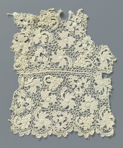 Fragment of crocheted lace with flowers and grape cluster
