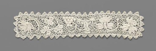Cuff of crocheted lace with flowers and a bunch of grapes