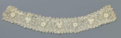 Strip of crocheted lace with rose and clover leaf