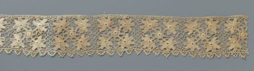 Strip of crocheted lace with four flowers around a circle