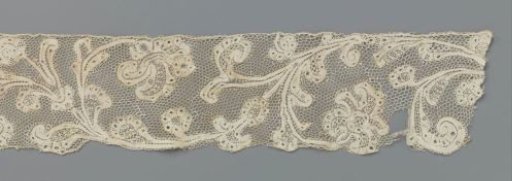Strip of bobbin lace with wavy volute vine