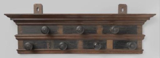 Coat rack of oak and ebony wood, executed with two rows of knobs