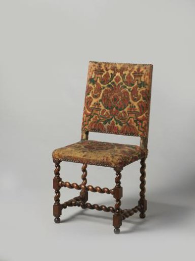 Armchair with splayed legs, upholstered in tripe with a pattern of red and green pomegranates