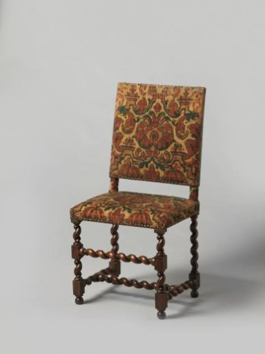 Armchair with splayed legs, upholstered in tripe with a pattern of red and green pomegranates