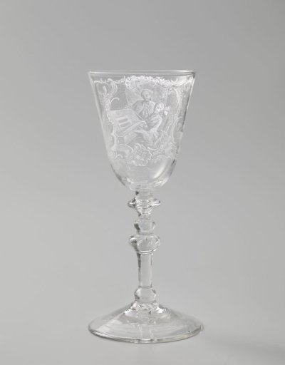 Wine glass with a woman behind a spinet