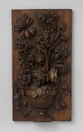 Furniture fragment with a high-relief carved flower vase