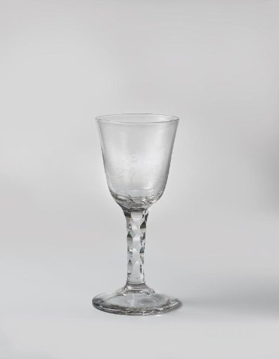 Chalice glass with a boy playing the flute in the company of a girl and a boy