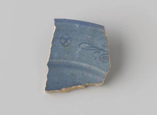 Fragment of yellow-fired earthenware, glazed blue on the front, with an incised decoration of a diamond and a stylized flower on the flat surface