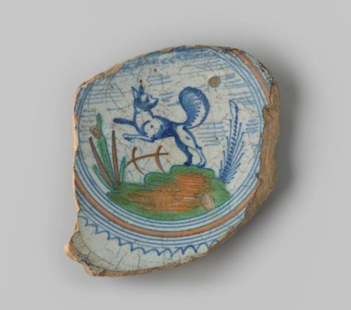 Fragment of yellow-fired earthenware, with footring, with a painting of a blue jumping fox in a landscape in blue, green and ochre yellow on the flat surface, surrounded by circles and a wavy edge in blue and yellow