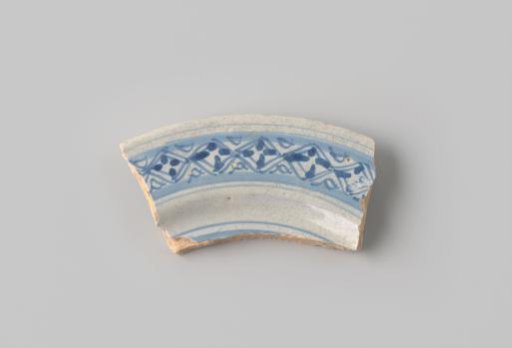 Fragment of red-firing earthenware with light grey glaze, decorated on the front with a blue border