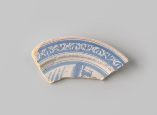 Fragment of yellow-firing earthenware with white glaze, decorated on the front with a border and part of a landscape in blue