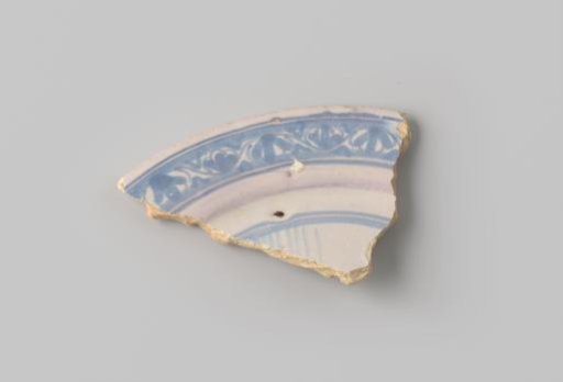 Fragment of yellow-firing earthenware with white glaze, decorated on the front with a blue border