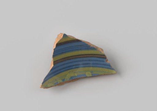 Fragment of red-firing earthenware, glazed on the upper side with blue glaze decorated with stripes in brown and yellow