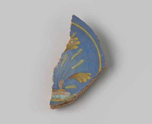 Sherd of reddish-baked earthenware, glazed blue on the upper side with a decoration of a scene of flowers growing in the earth in brown, white, yellow, orange and green, and several circles in brown and yellow around them