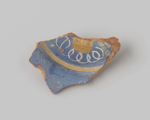 Fragment of reddish-fired earthenware, glazed blue on the upper side with a painting of two flowers in white, brown and ochre, and two green leaves