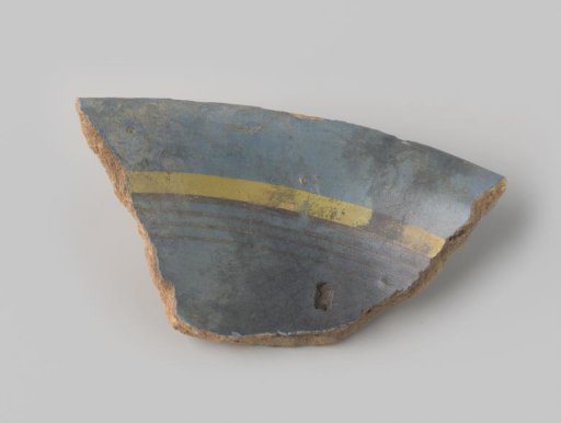 Fragment of reddish-fired earthenware, glazed blue on the upper side, decorated with a painting of stripes in dark brown and yellow