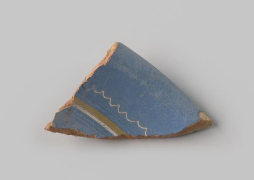 Fragment of reddish-fired earthenware, glazed blue on the upper side, painted with straight and wavy stripes in yellow, blue and white