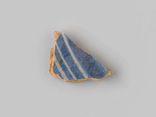 Fragment of reddish-fired earthenware, glazed blue on the upper side, with several stripes painted in white
