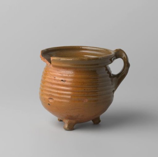 Cooking pot of red-firing earthenware, on three legs, with a handle, glazed on the inside and outside, rim damaged