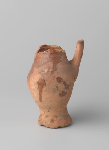 Pitcher of red-baked earthenware, glazed on the inside and partly on the outside, with damaged rim, foot and handle