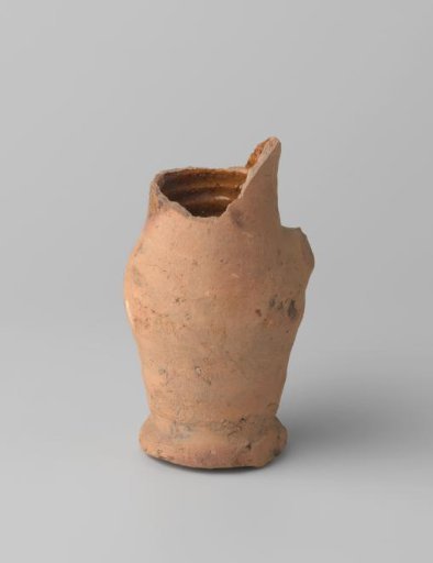 Pitcher of red-baked earthenware, glazed on the inside and partly on the outside, with damaged rim, foot and handle