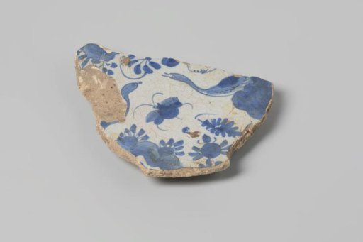 Sherd of earthenware with lead glaze on the reverse and tin glaze on the front, decorated with flowers and animals in blue, marked on the underside, damaged