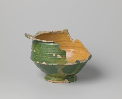 Pot of white-firing clay, glazed yellow on the inside and green on the outside, damaged
