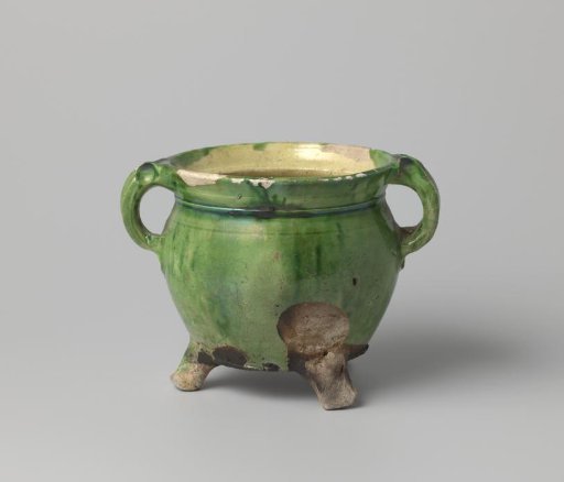 Pot of white-firing clay, glazed yellow on the inside and green on the outside, damaged