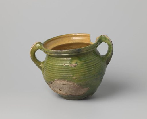 Pot of white-firing clay, glazed yellow on the inside and green on the outside, damaged