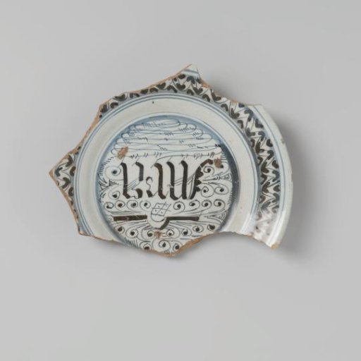 Earthenware plate, glazed lead on the underside and white tin glaze on the upper side, and in blue among other things the letters omega M A, damaged