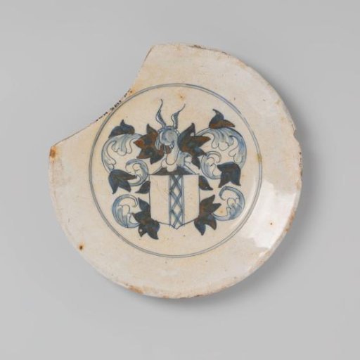 Earthenware plate, entirely covered in white tin glaze and decorated in blue with the coat of arms of Amsterdam, damaged