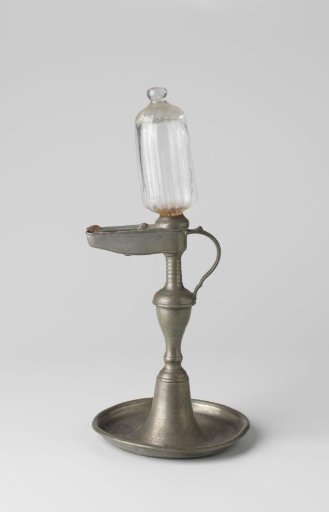 A tin oil lamp with a glass reservoir