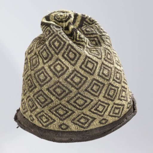 Cap, knitted, dome of black silk with diamond-shaped, geometric ornaments of gold thread and a curled brim of plain black silk