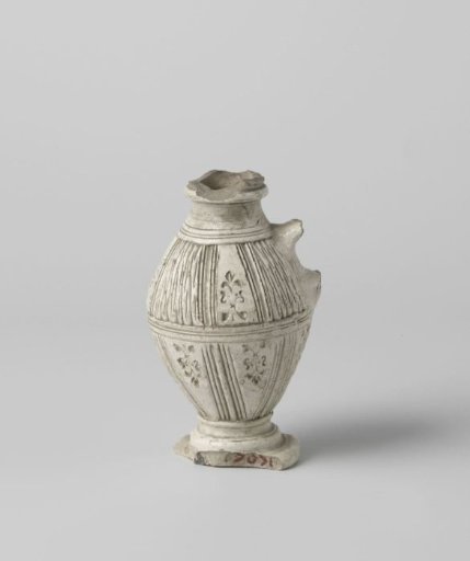 Fragment of a jug with chip carving and stylized floral scrolls