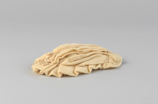 Cap, pleated and decorated with cord and lace.