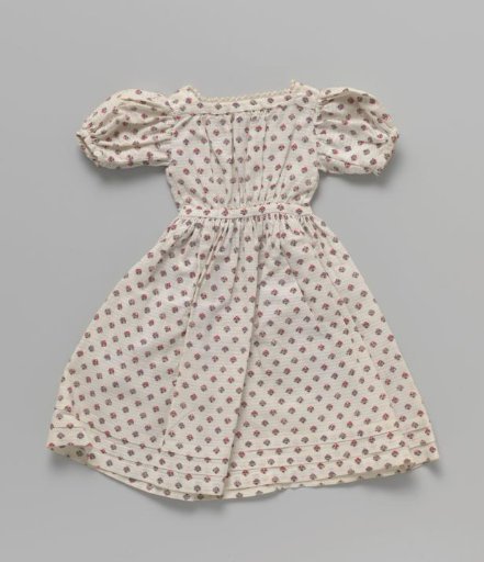 Dress, with puffed sleeves, two lacing fronts and picot trim along the neckline.