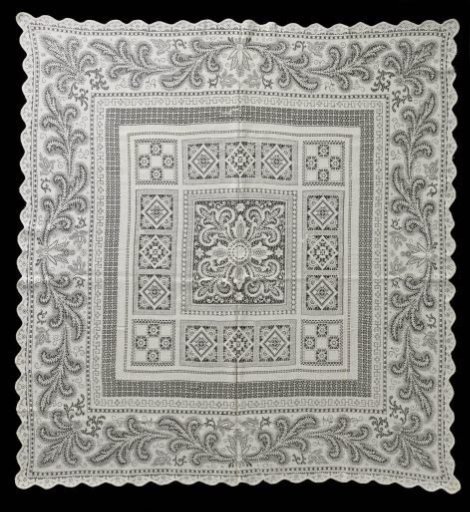 Cotton baptismal gown of machine-made lace with geometric pattern and acanthus leaves