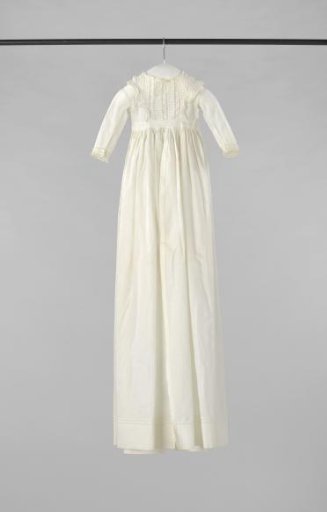 White baptismal gown with collar and sleeves trimmed with strips of Valenciennes lace