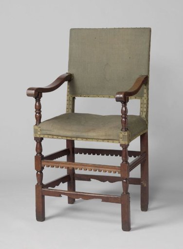 Armchair, upholstered in green worsted. Decorated with dentil mouldings, among others. Front rail scalloped in cartouche shape.
