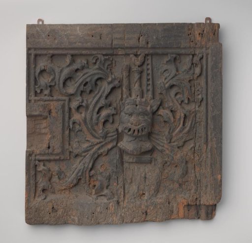 Door of a cabinet with deep carving featuring a coat of arms whose crest consists of a whipstaff with a rooster and a ladder