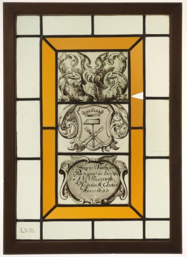 Pane with a coat of arms featuring smith's attributes, with inscription "Heinrich Vierhaus Provisor in Leiden und Margaretha Meyernick Eheleuthe Ao 1690"